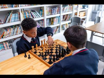 Student playing chess for scholarship