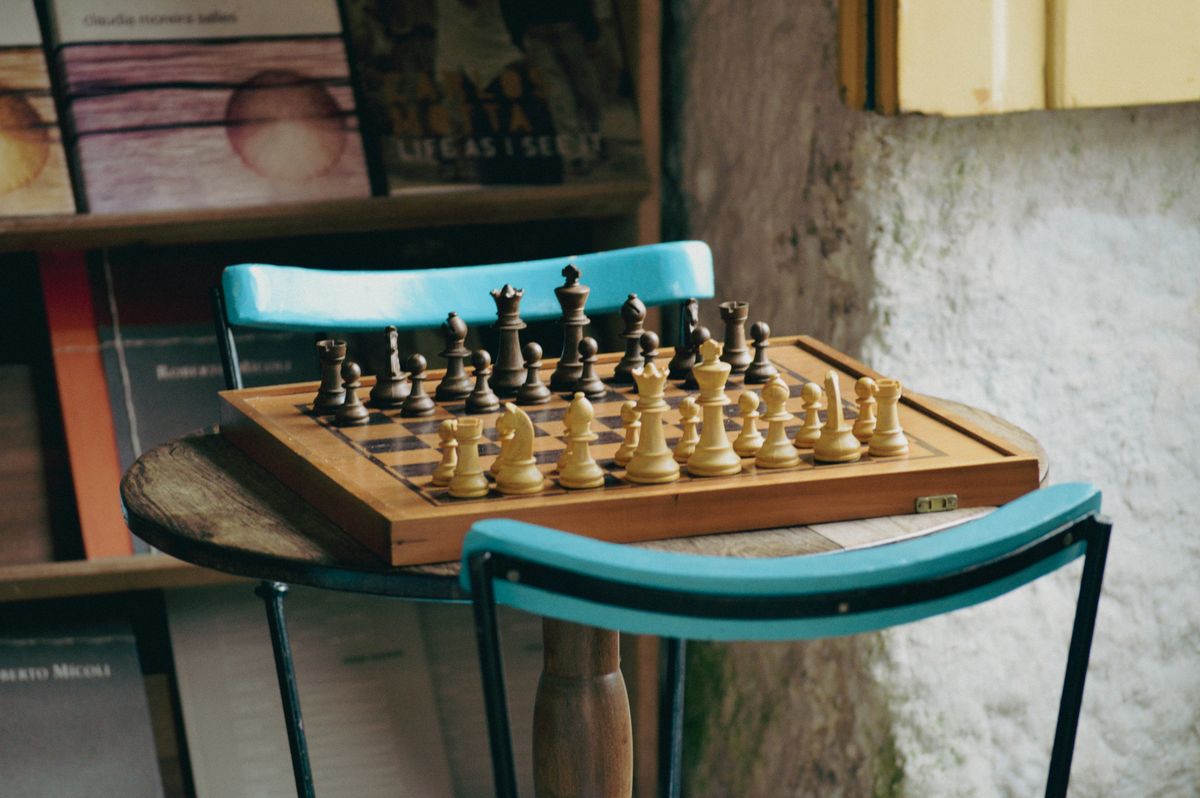 Chessboard set up on a wooden table ready for a game with chess notation