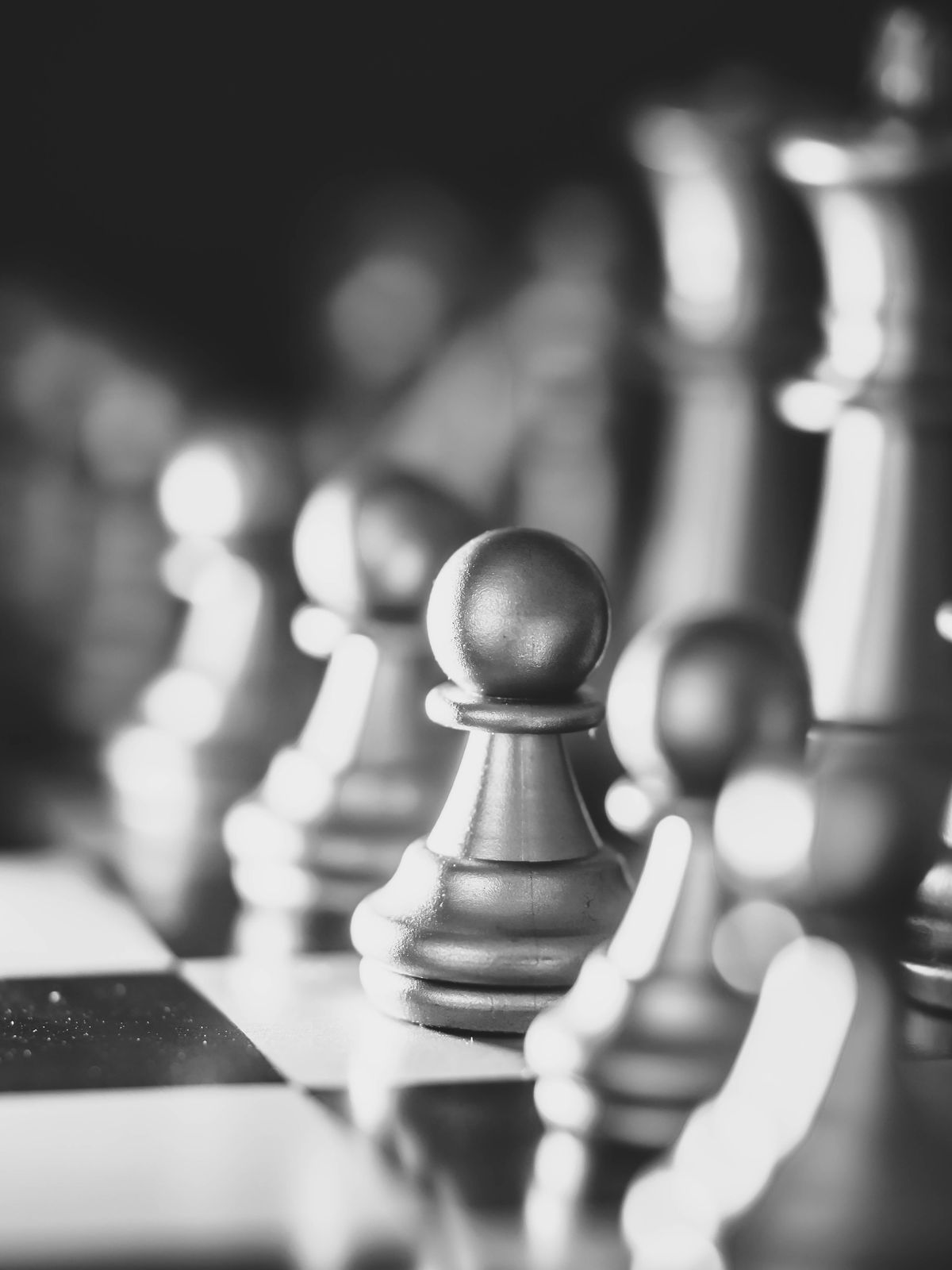 Shiny chess pieces on a board representing tactical positions