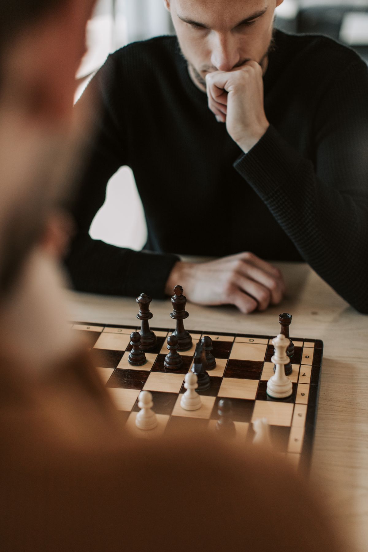 Chess player deep in thought during a competitive match like the FIDE Candidates Tournament
