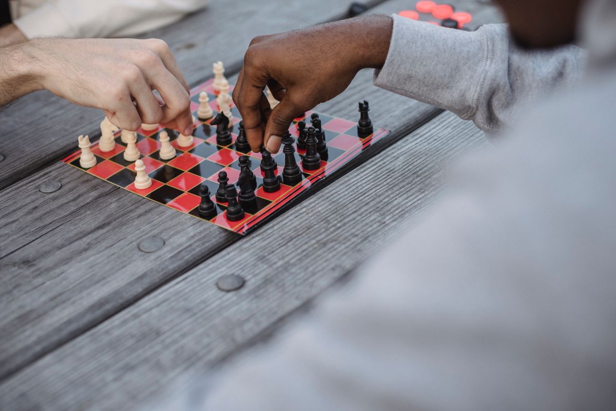 Young players engaged in a chess match at a tournament like Tata Steel Chess