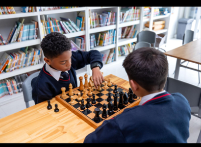 Student playing chess for scholarship